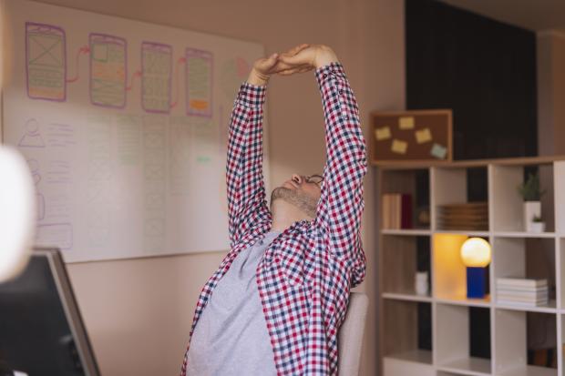 Person stretching at desk Person stretching at desk