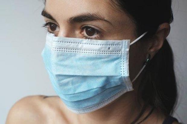 Image of a person wearing a fluid resistance surgical mask