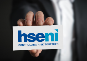 A picture of a person holding a HSENI business card